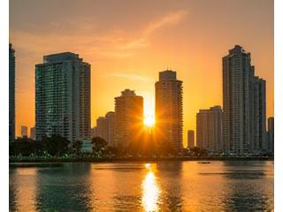Miami skyline at sunset with subtle digital health interface overlays, symbolizing local connection and innovation